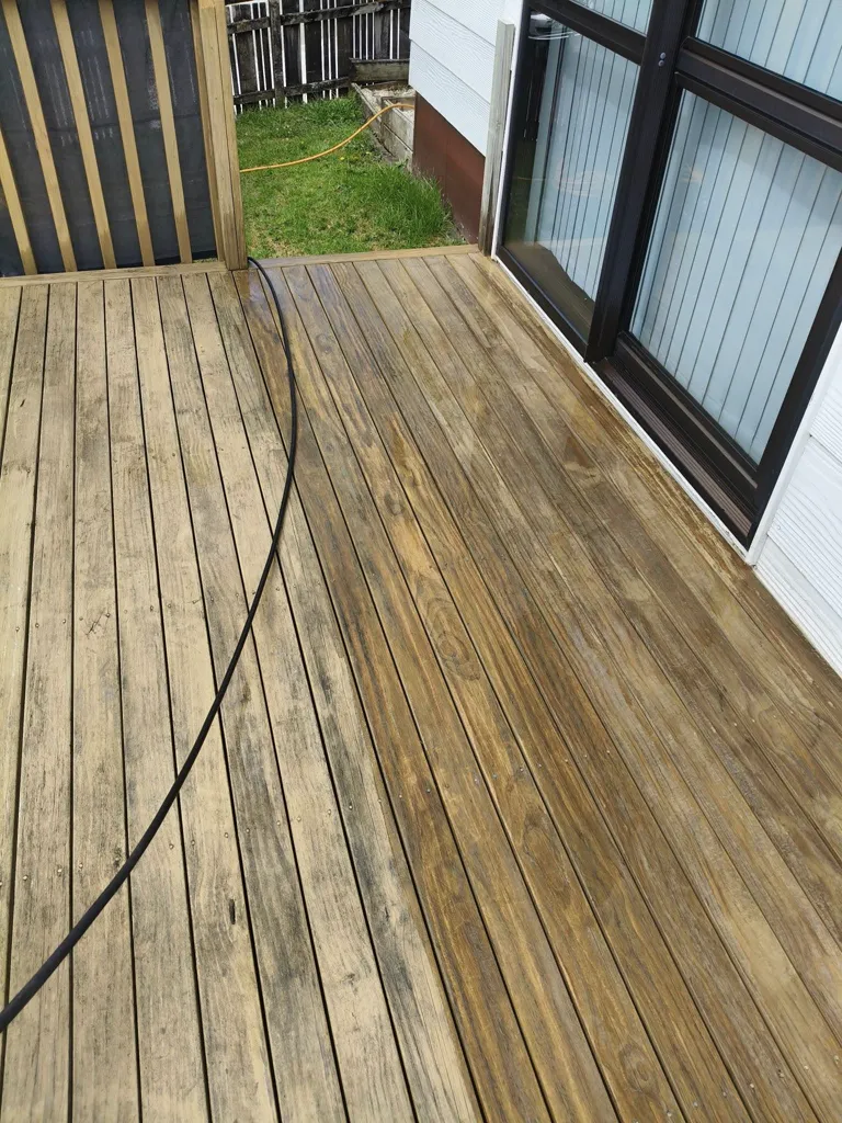 Timber deck part way through exterior cleaning, showing the cleaned and uncleaned halves