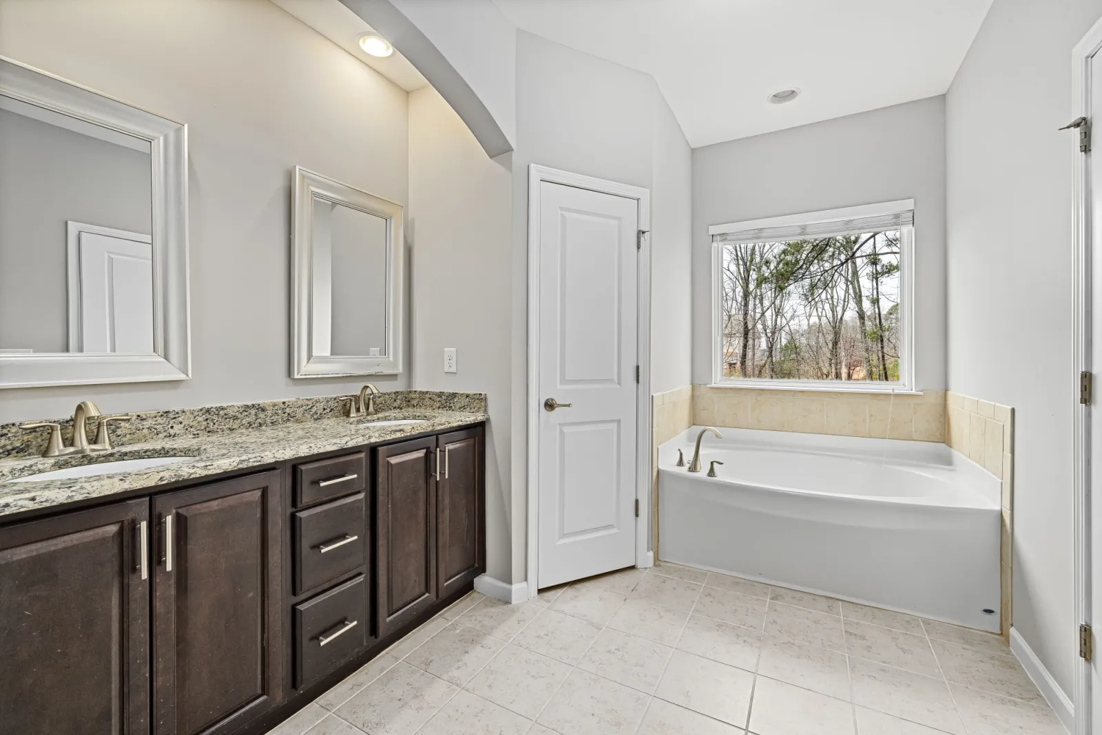 Light-filled bathroom with tiled shower, vanity and bath