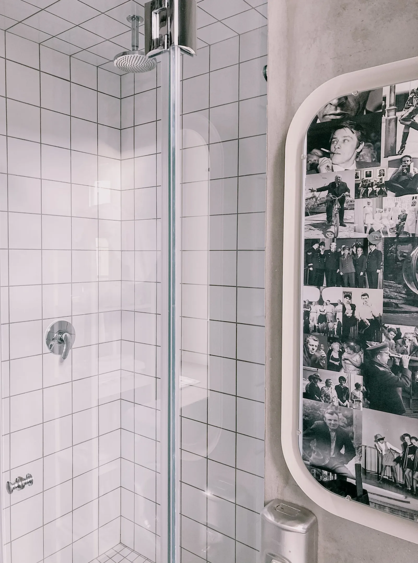 Tiled shower with a glass enclosure and wall-mounted fittings