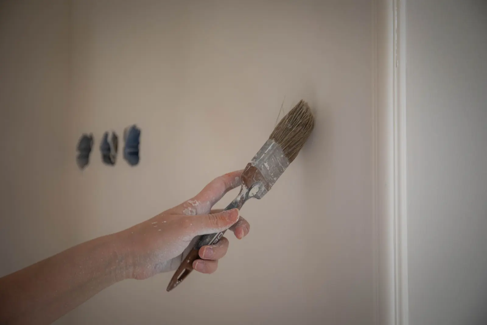 Brush cutting a clean paint line along a wall