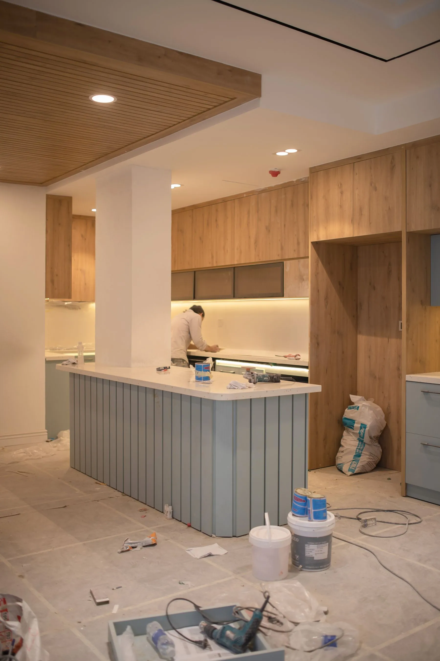 Kitchen renovation in progress with cabinetry and finishing tools